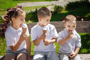 three cute kids eating ice cream
