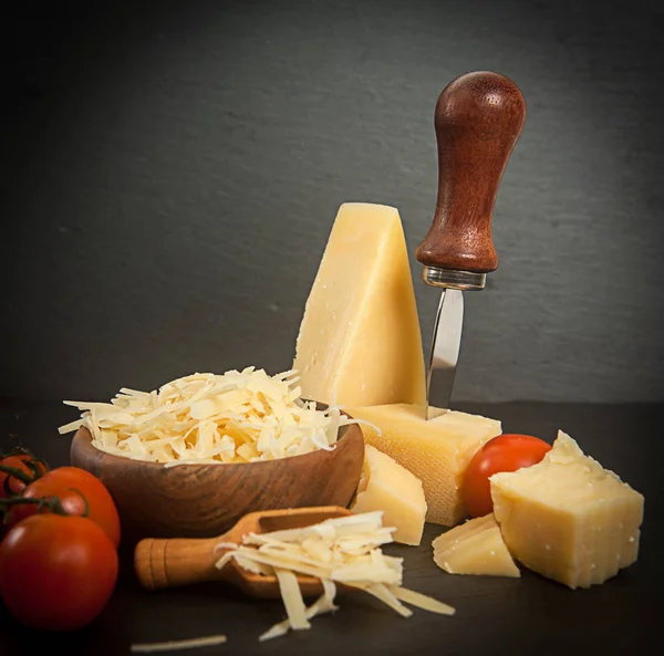 Parmesan cheese in wooden spoon — Stock Photo, Image