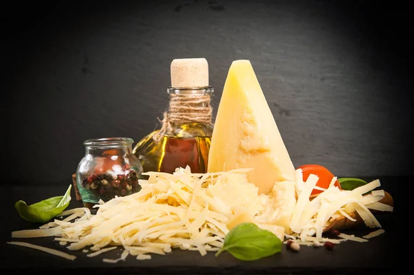 Grated Parmesan cheese in wooden spoon — Stock Photo, Image