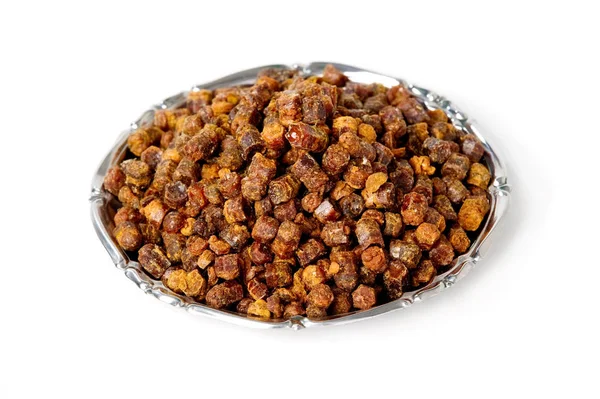 Propolis granules inside plate, bee product — Stock Photo, Image