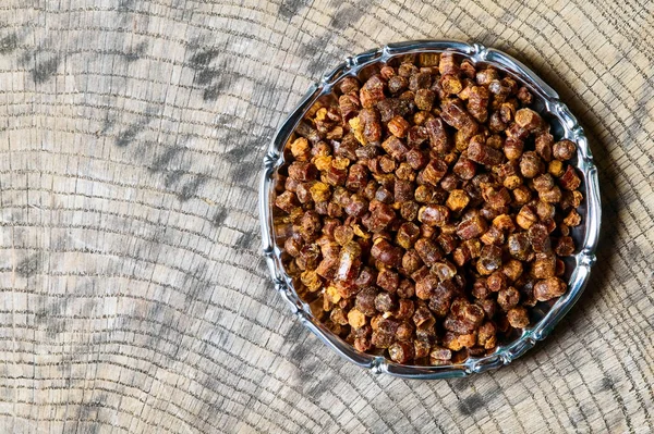 Propolis granules inside plate, bee product — Stock Photo, Image