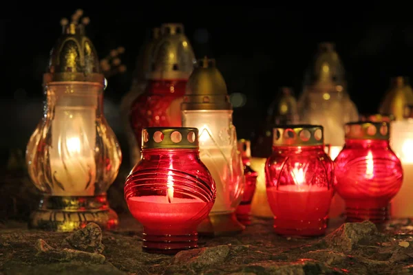 Lighted grave candles in the darkness — Stock Photo, Image