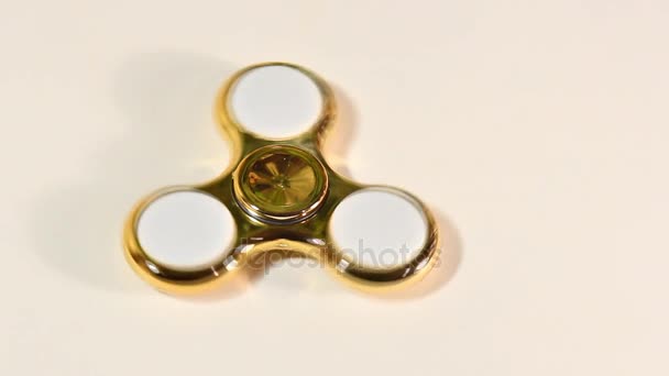 Gouden fidget spinner roteert. Hand spinner is een populaire speelgoed voor kinderen en volwassenen. — Stockvideo