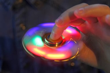 Işık kıpır spinner elinde. Popüler moda oyuncak yakın çekim.