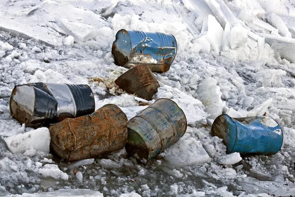 Damaged barrels in ice. — Stock Photo, Image