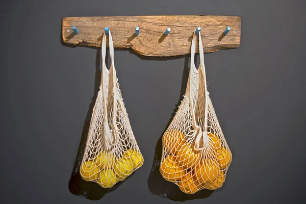 String bags with citrus fruits.