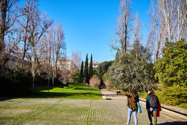 Lisbon, Portugal - January, 2018. Gulbenkian park and garden. Tourists walk in the park and study its territory. Bright warm sunny day.