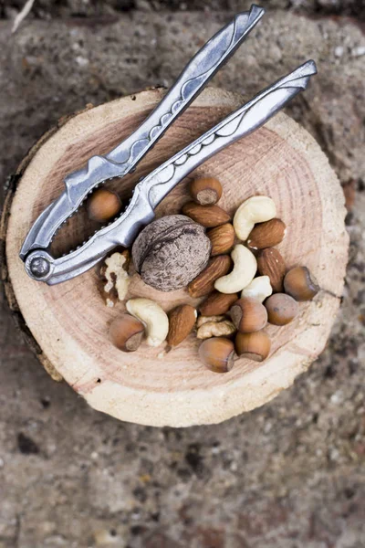 Noisettes brunes entières et hachées avec Casse-noisette — Photo