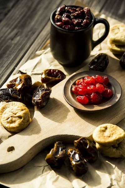 dried fruit on the kitchen plank - dates, figs and dried cherries