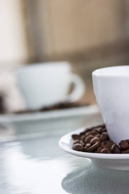 Espresso kahve. Bir uçan daire ve küçük bir beyaz fincan kahve çekirdekleri