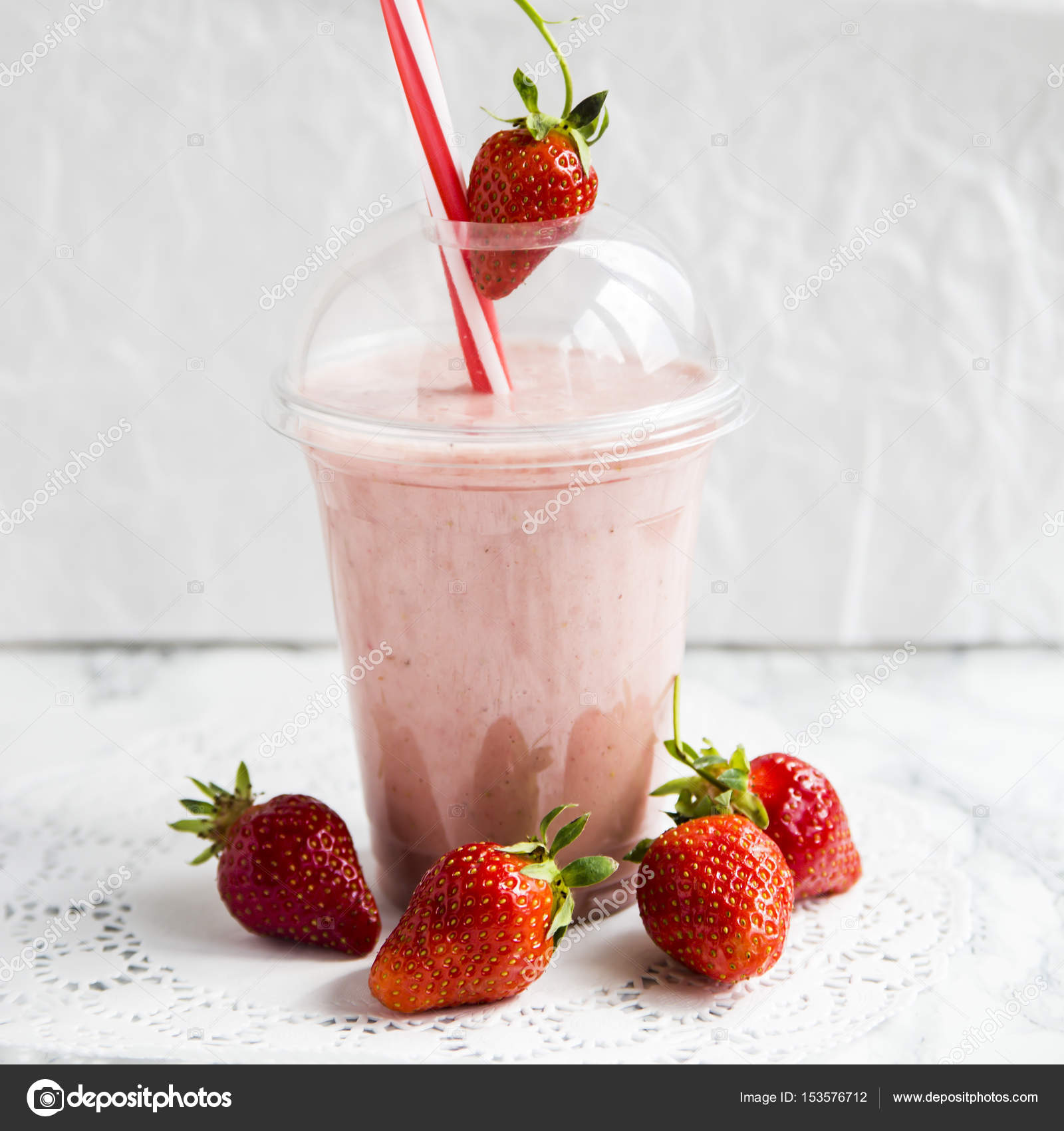 Healthy summer smoothies to go in a plastic cup Stock Photo by