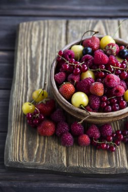 Yaz meyveleri bir kil kase bir ahşap stand