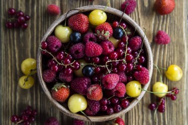 Yaz meyveleri bir kil kase bir ahşap stand