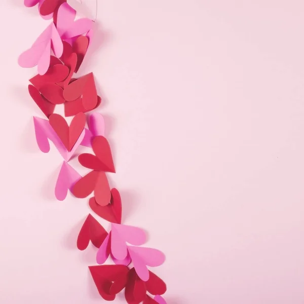 Paper hearts on a pink background for Valentines Day. — Stock Photo, Image