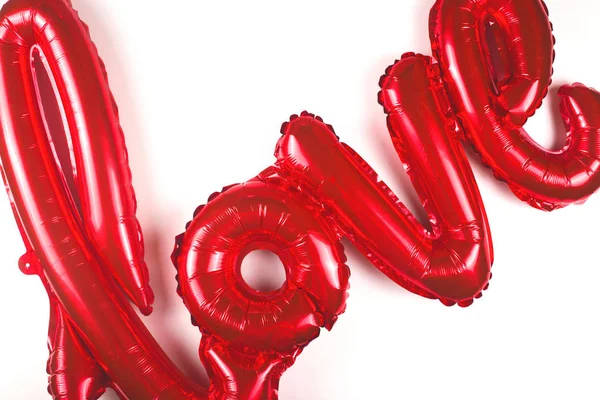 A balloon in the shape of the word love on white background. — Stock Photo, Image