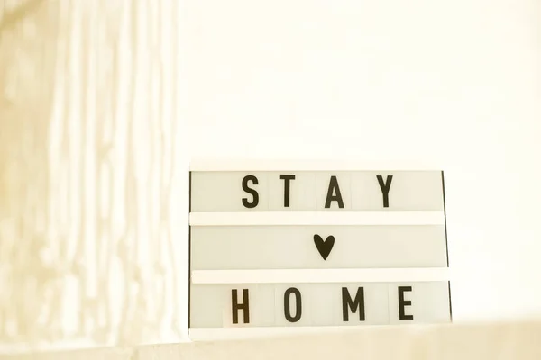 The inscription stay home in a bright interior. Quarantine during an epidemic Covid-19. — Stock Photo, Image