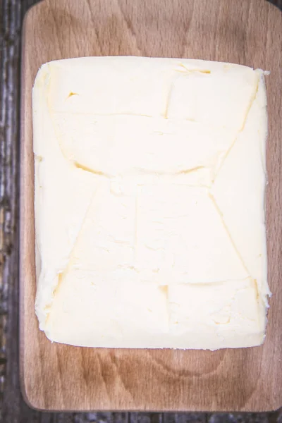 Butter on a wooden chopping board — Stock Photo, Image