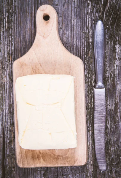 Butter on a wooden chopping board — Stock Photo, Image