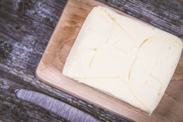 Butter on a wooden chopping board — Stock Photo, Image