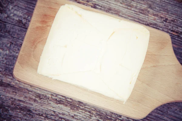 Butter on a wooden chopping board — Stock Photo, Image