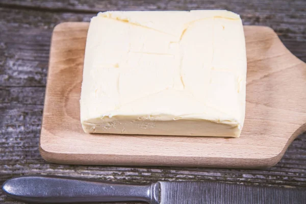 Butter on a wooden chopping board — Stock Photo, Image