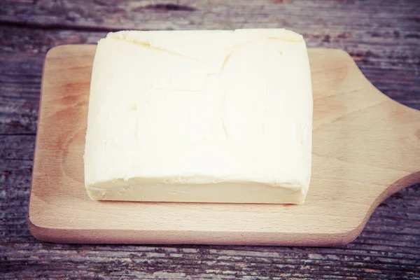 Mantequilla en una tabla de cortar de madera — Foto de Stock