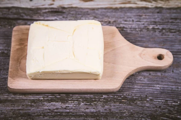 Butter on a wooden chopping board — Stock Photo, Image