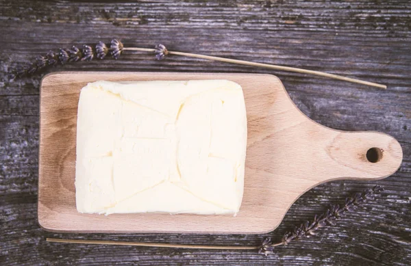 Butter on a wooden chopping board — Stock Photo, Image