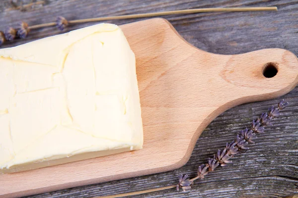 Butter on a wooden chopping board — Stock Photo, Image