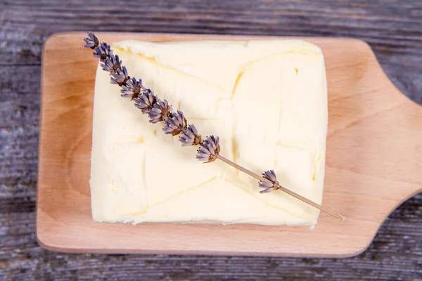 Butter on a wooden chopping board — Stock Photo, Image