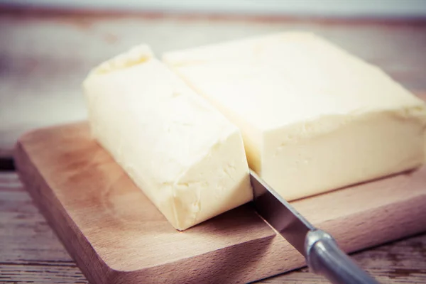 Butter on a wooden chopping board — Stock Photo, Image