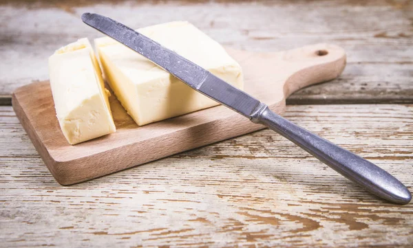 Butter on a wooden chopping board — Stock Photo, Image