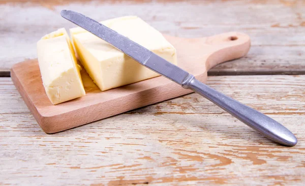 Butter on a wooden chopping board — Stock Photo, Image