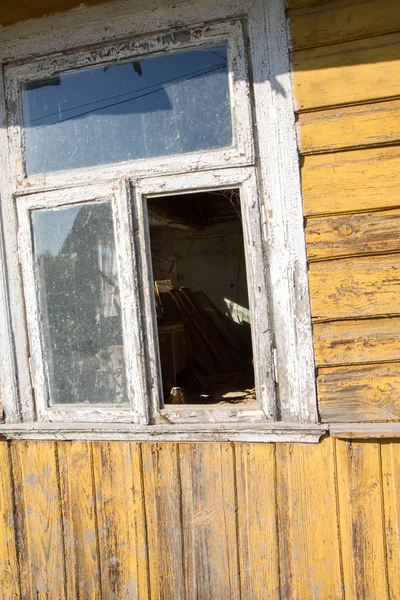 Old wooden house with a broken window