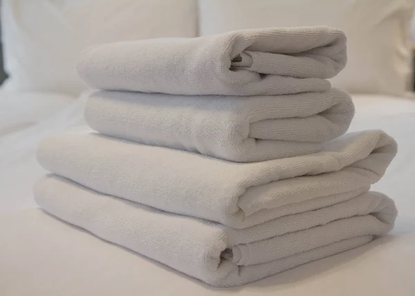 一堆毛巾放在酒店房间的床上 — 图库照片