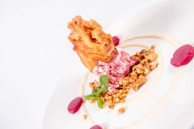 Lehçe-Litvanyaca geleneksel beyaz zemin üzerine taze nane ile dekore edilmiş dondurma, kavrulmuş fındık ve ahududulu jöle ile pasta ('ağaç kek') - sekacz (Polonya) veya sakotis (Litvanyaca) tükürmek