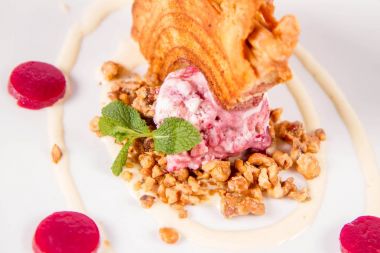 Lehçe-Litvanyaca geleneksel beyaz zemin üzerine taze nane ile dekore edilmiş dondurma, kavrulmuş fındık ve ahududulu jöle ile pasta ('ağaç kek') - sekacz (Polonya) veya sakotis (Litvanyaca) tükürmek