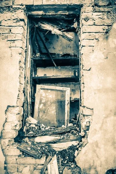Broken window of a devastated house