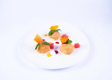 Erik köfte tarçın, beyaz çikolata ve beyaz zemin üzerine vanilya sosu ile