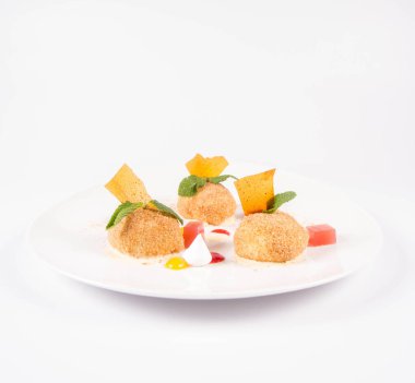 Erik köfte tarçın, beyaz çikolata ve beyaz zemin üzerine vanilya sosu ile