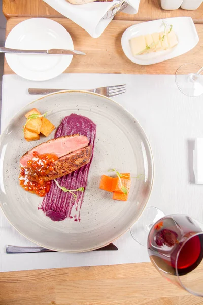 Roast duck breast, red cabbage with apple, roasted potatoes,mountain ash and honey sauce