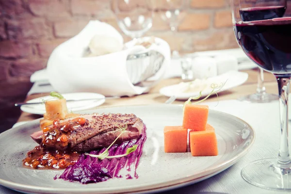 Roast duck breast, red cabbage with apple, roasted potatoes,mountain ash and honey sauce