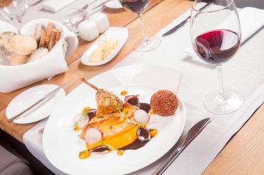 Gine fowl, kabak püresi, kızarmış buğday, sos sos bir restoranda