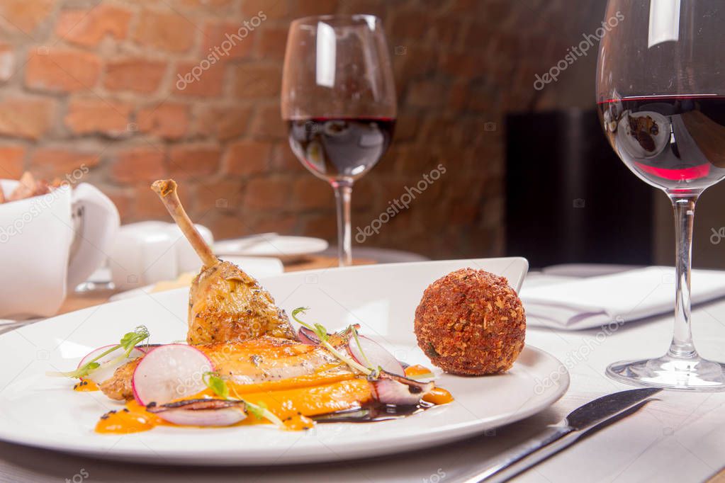 Guinea fowl, pumpkin puree, fried buckwheat, gravy sauce served in a restaurant