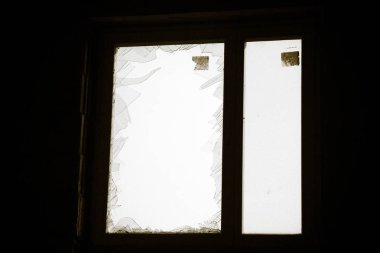 Kırık bir pencere ve cam kırıkları