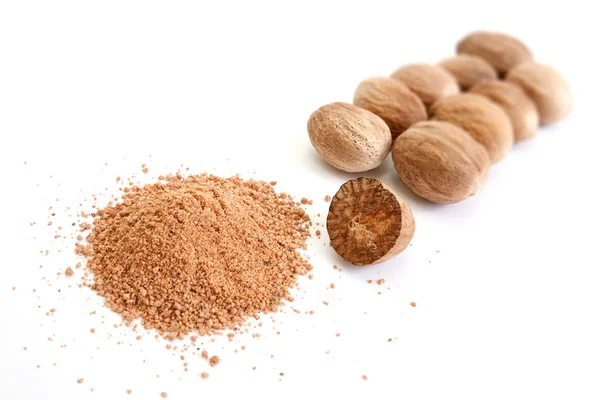 Nutmegs and powder — Stock Photo, Image