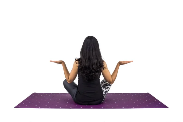 A woman yoga teacher in sukhasana posture 로열티 프리 스톡 이미지