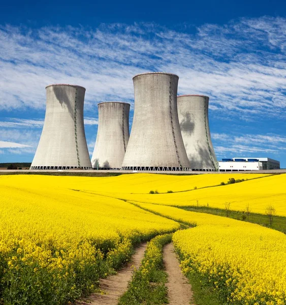 Nuclear power plant, field of rapeseed and rural road — Stock Photo, Image