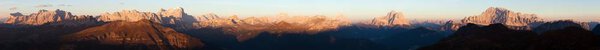 Evening sunset colored panoramic view of Alps Dolomites mountains from Col di Lana, Civetta, Pelmo, Tofana, Fanes, Cristallo, Antelao and others, Italian dolomites, Italy