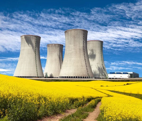 Nuclear power plant and field of rapeseed — Stock Photo, Image